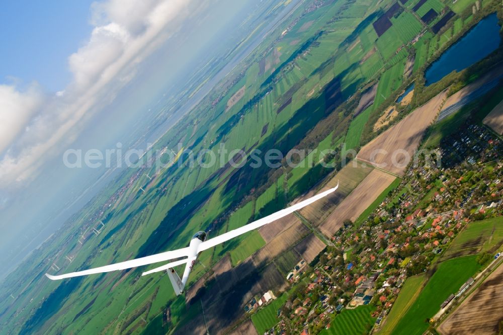 Aerial photograph Stade - Glider and sport aircraft LS-4 D-4103 flying below cumulus clouds over the airspace of Stade in the state Lower Saxony, Germany