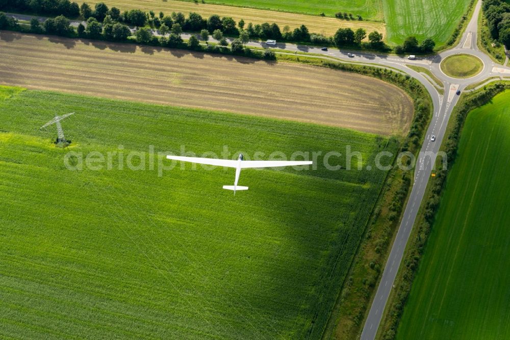 Aerial image Stade - Glider and sport aircraft SF-27 flying over the meadows and a roundabout near Stade in the state Lower Saxony, Germany