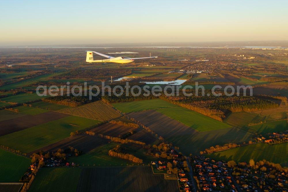 Stade from above - Glider and sport aircraft Glasfluegel Mosquito D-5561 flying over while evening light the airspace in Stade in the state Lower Saxony, Germany