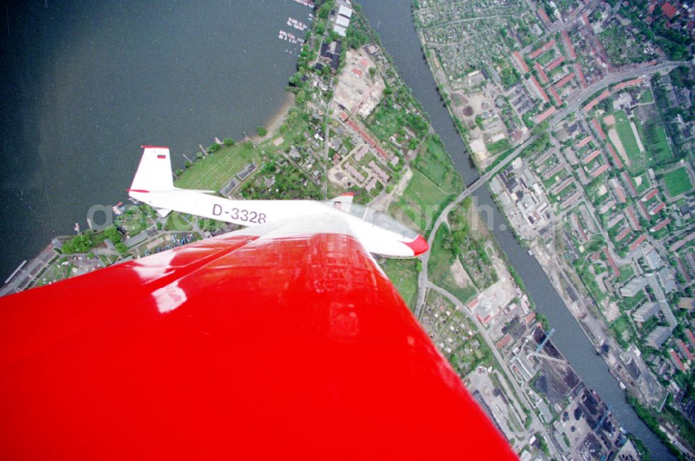 Brandenburg an der Havel from the bird's eye view: Glider and sports aircraft PZL Bielsko SZD-9 Bocian with the registration D-3328 in a banked turn in flight over the airspace in Brandenburg an der Havel in the state Brandenburg, Germany