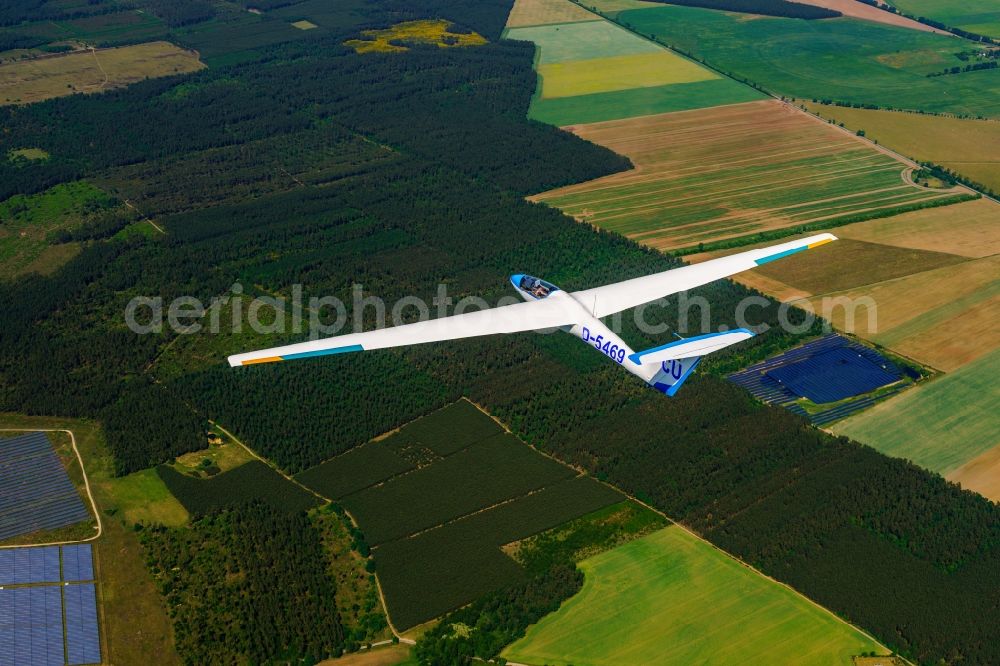 Meyenburg from above - Glider and sport aircraft SZD-36 Cobra flying over the airspace in Meyenburg in the state Brandenburg, Germany. The PZL Bielsko SZD-36 Cobra 15 is a single-seater high performance glider in wood construction