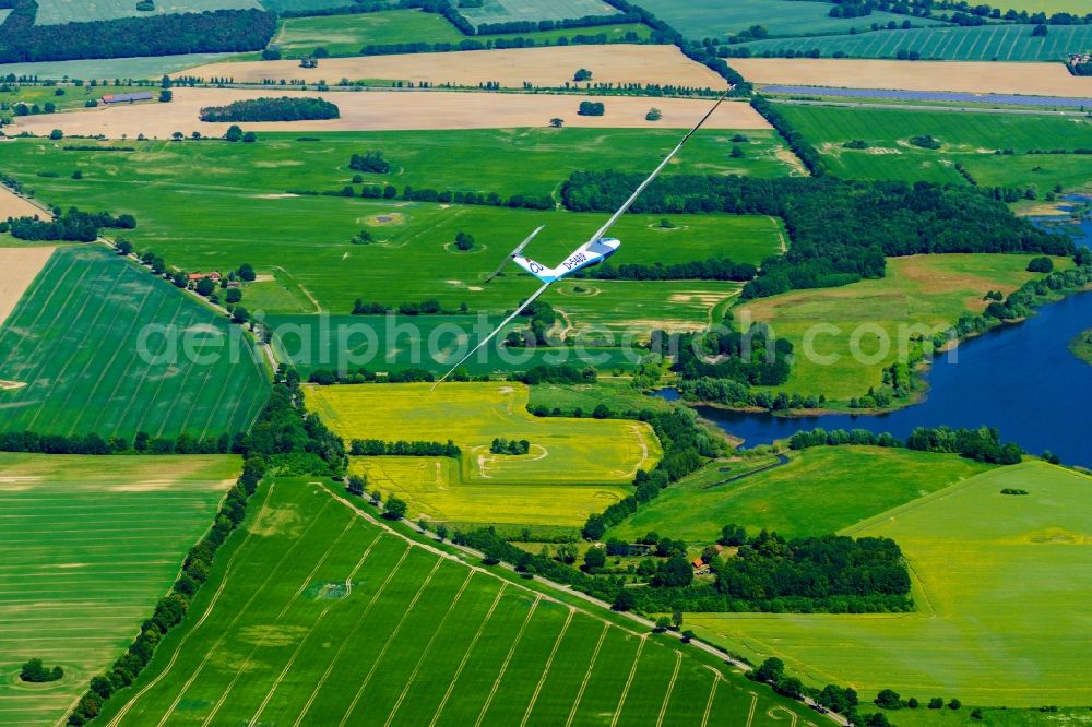 Kümmernitztal from the bird's eye view: Glider SZD-36 Cobra in flight over the Predoeler reservoir in Gerdshagen in the state of Brandenburg, Germany