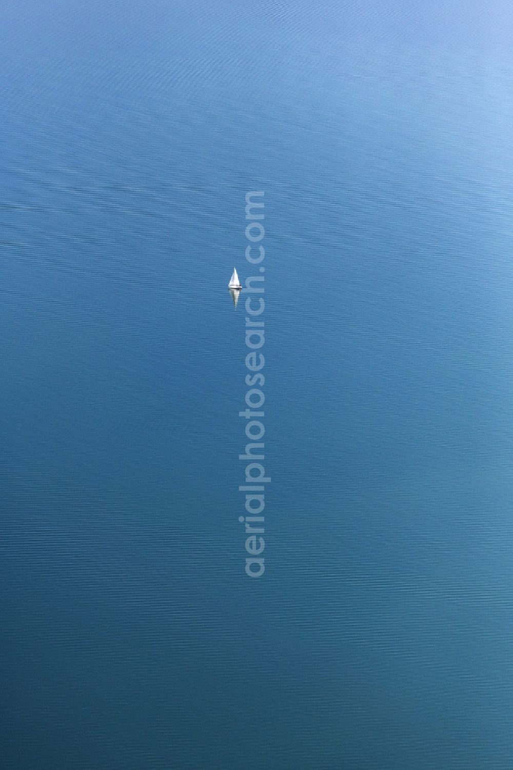 Chiemsee from above - Sailboat under way on Chiemsee in the state Bavaria, Germany