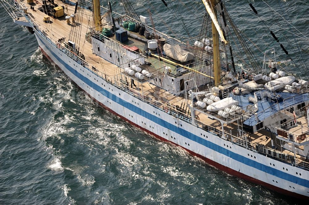 Aerial photograph Rostock - View of the training ship MIR in the Baltic Sea off Rostock in Mecklenburg Western Pomerania. It is owned by the Admiral Makarov Academy in Saint Petersburg, was built in the Lenin shipyard in Danzig and is considered one of the fastest tall ships in the world