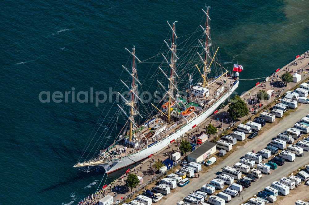 Rostock from the bird's eye view: Sailing ship Polish sailing training ship Dar Modziey in the port of Rostock Warnemuende for the Hansesail 2022 in the state Mecklenburg - Western Pomerania, Germany