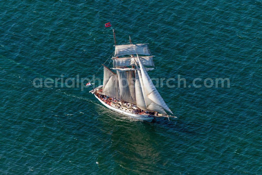 Aerial image Rostock - Sailing ship two-masted gaff topsail schooner JR Tolkien in motion with white sails on the Baltic Sea in the district of Warnemuede in Rostock on the Baltic Sea coast in the state Mecklenburg - Western Pomerania, Germany