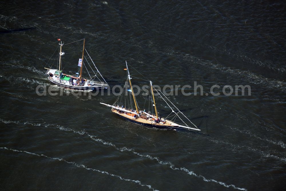 Rostock from above - Sailboat underway on the Unterwarnow in Rostock in the state Mecklenburg - Western Pomerania