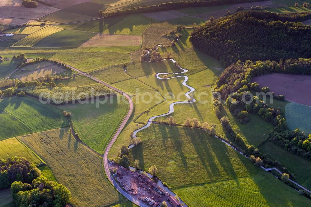 Ebern from the bird's eye view: Meandering, serpentine curve of a river Baunach in Ebern in the state Bavaria, Germany