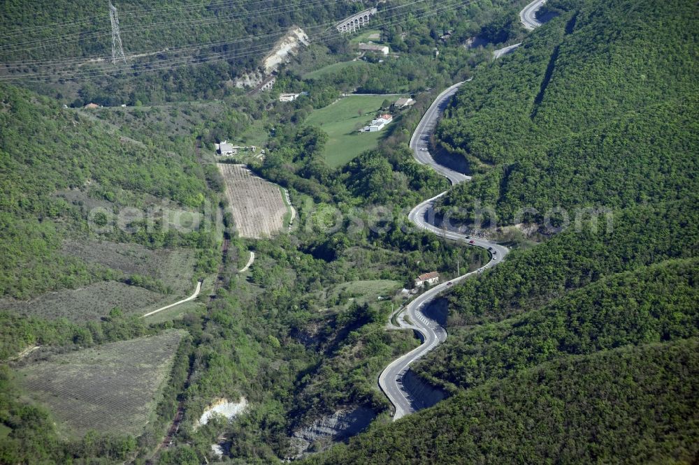 Aubignas from the bird's eye view: Serpentine-shaped curve of a road N102 - in Aubignas in Auvergne Rhone-Alpes, France