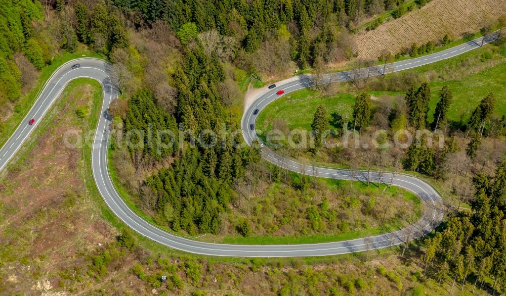 Brilon from the bird's eye view: Serpentine-shaped curve of a road guide in Brilon in the state North Rhine-Westphalia, Germany