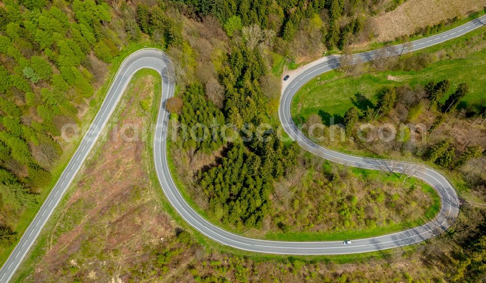 Brilon from the bird's eye view: Serpentine-shaped curve of a road guide in Brilon in the state North Rhine-Westphalia, Germany