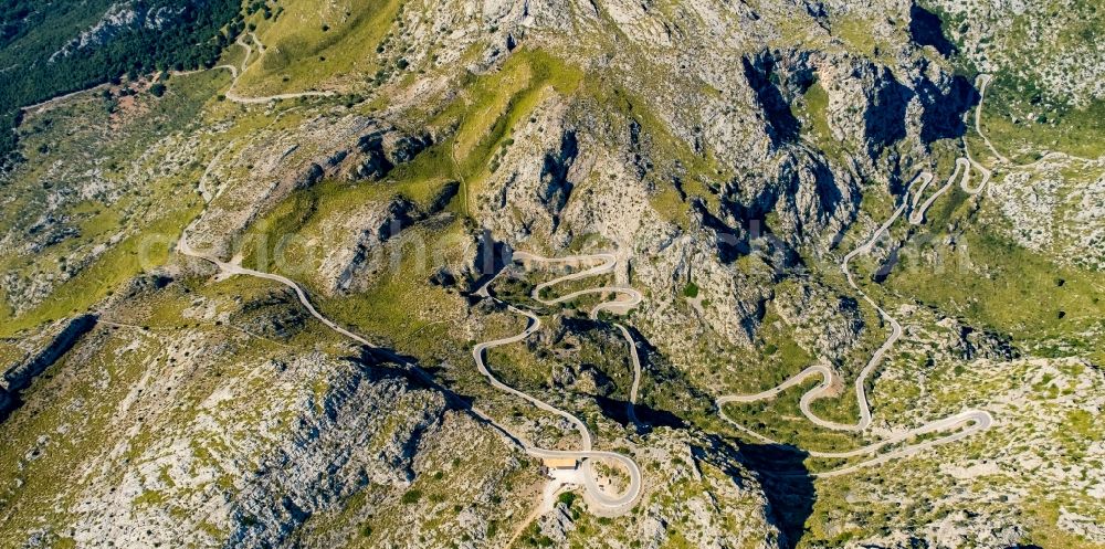 Aerial image Escorca - Serpentine-shaped curve of a road guide in Escorca at Serra de Tramuntana in Balearic island of Mallorca, Spain