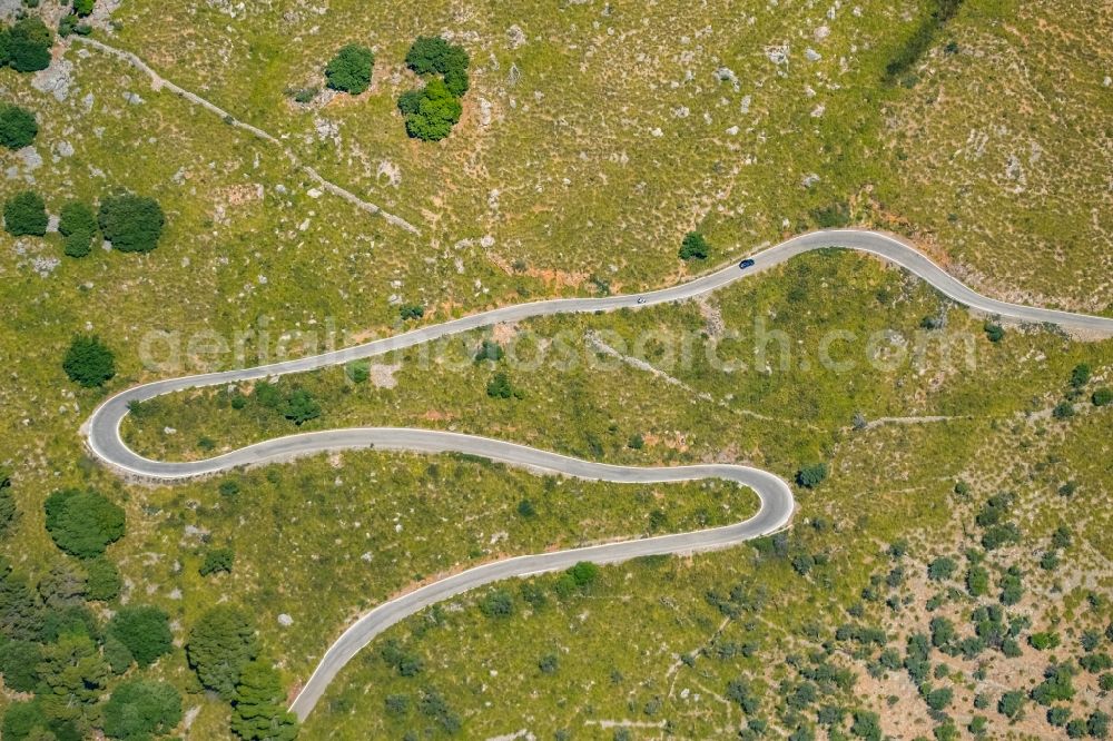 Aerial photograph Escorca - Serpentine-shaped curve of a road guide in Escorca at Serra de Tramuntana in Balearic island of Mallorca, Spain