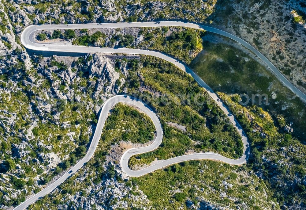 Aerial image Escorca - Serpentine-shaped curve of a road guide in Escorca at Serra de Tramuntana in Balearic island of Mallorca, Spain