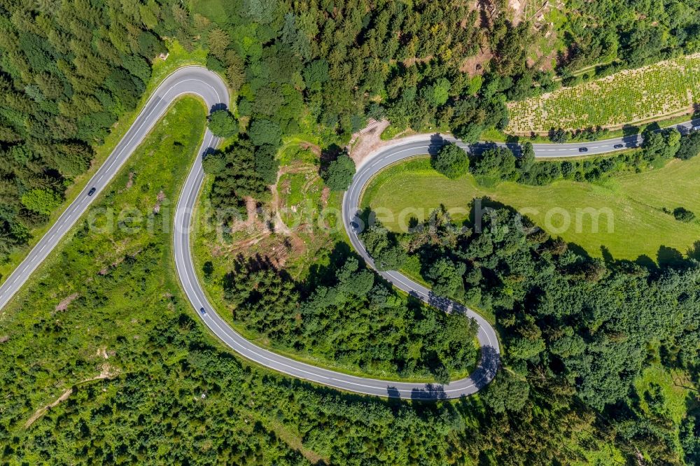 Brilon from the bird's eye view: Serpentine-shaped curve of a road guide of street L870 Am Bilstein in Brilon in the state North Rhine-Westphalia, Germany