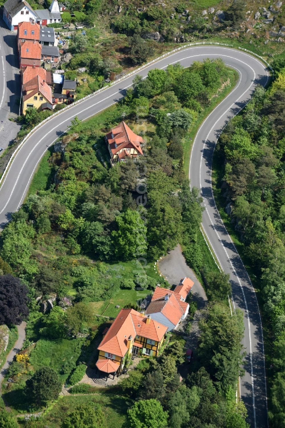 Gudhjem from above - Serpentine-shaped curve of a road Norresand guide in Gudhjem in Region Hovedstaden, Denmark