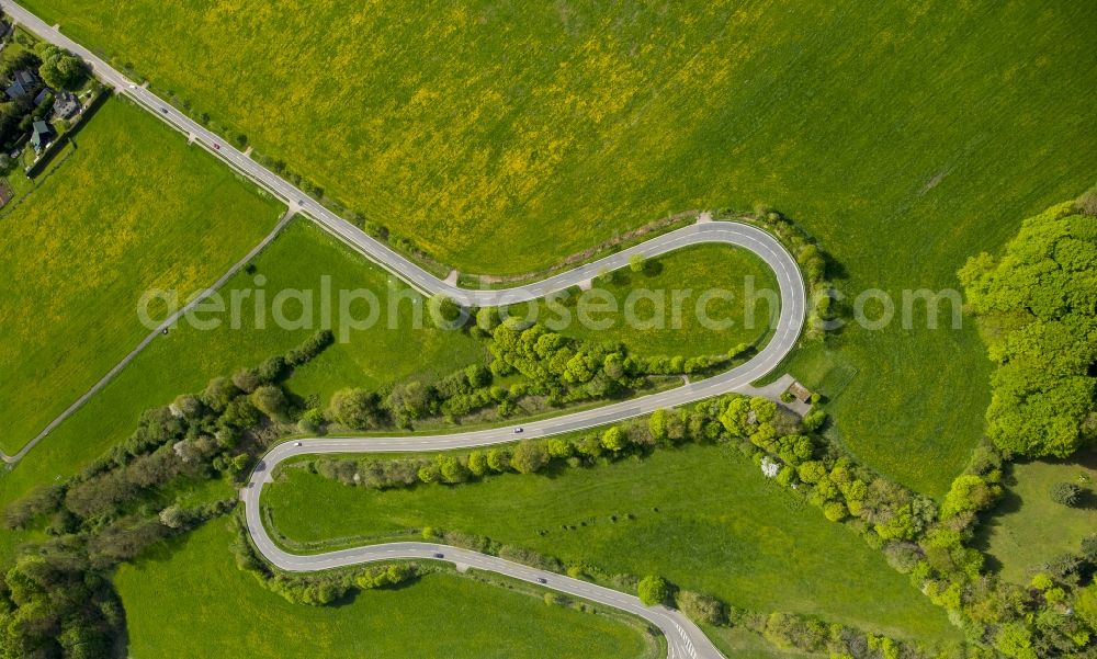 Aerial image Steinfeld - Serpentine-shaped curve of a road guide in Steinfeld in the state North Rhine-Westphalia