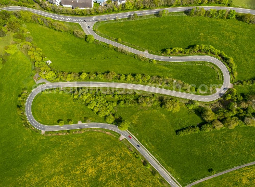 Aerial image Steinfeld - Serpentine-shaped curve of a road guide in Steinfeld in the state North Rhine-Westphalia