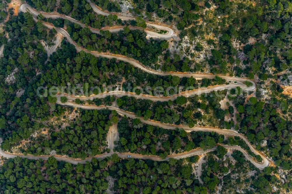 Aerial image Valldemossa - Serpentine-shaped curve of a road guide in Valldemossa in Balearic island of Mallorca, Spain