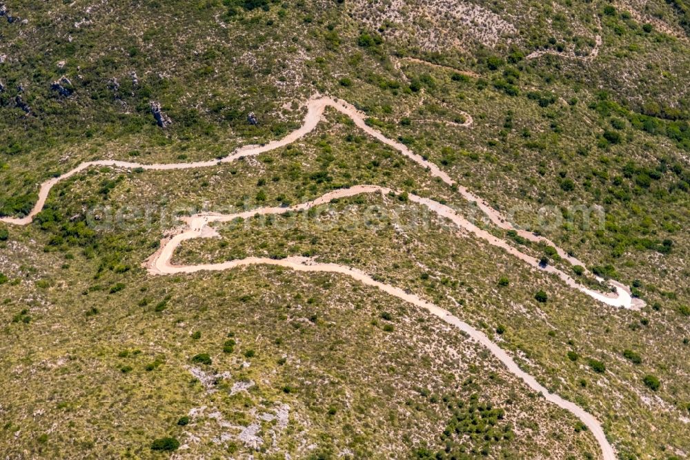 Cala Mesquida from above - Serpentine-shaped curve of a road guide in Cala Mesquida in Balearic islands, Spain