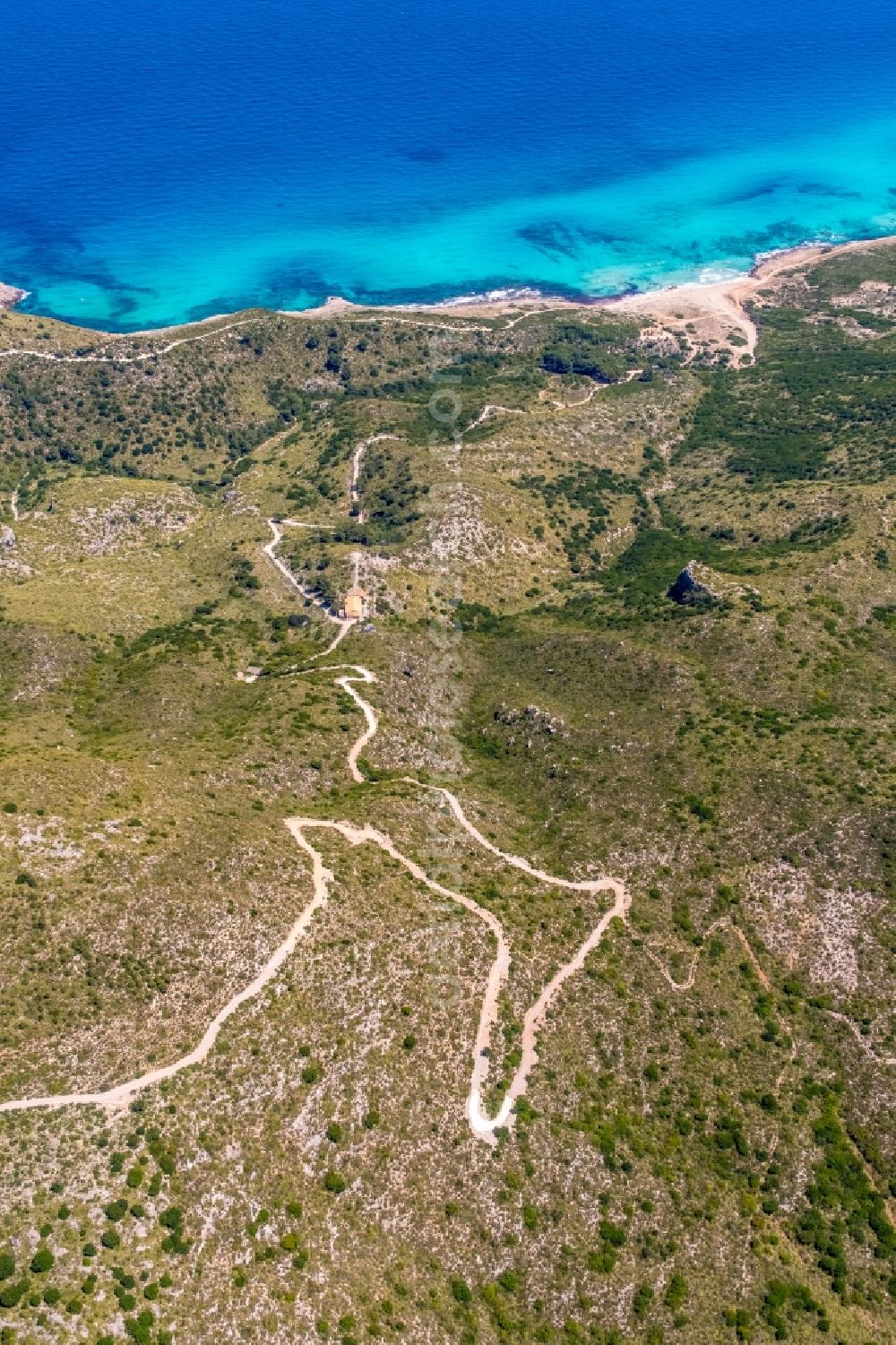 Cala Mesquida from the bird's eye view: Serpentine-shaped curve of a road guide in Cala Mesquida in Balearic islands, Spain