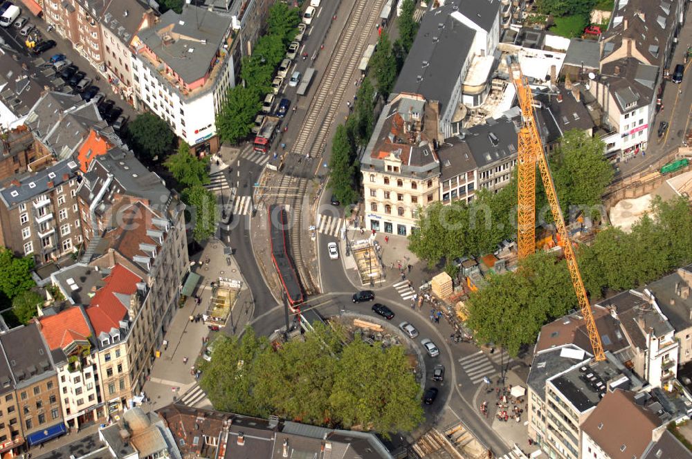 Köln from the bird's eye view: Blick auf den Kreisverkehr an der U-Bahnhaltestelle Chlodwigplatz. Hier treffen sich Karolingerring, Ubierring und Bonner Straße. Mit auf dem Bild ist die Severinstorburg, benannt nach der Pfarrei St. Severinus. Die Severinstorburg ist eine von vier erhalten gebliebenen Stadttorburgen der mittelalterlichen Stadtmauer von Köln und das Wahrzeichen des Severinsviertels in Köln und ein exzellentes Beispiel mittelalterlicher Befestigungsbaukunst. Die Baustelle im Vordergrund gehört zum U-Bahnbau. Die Bauaufsicht wurde im August 2009 der KVB entzogen und an die Düsseldorfer Ingenieurgesellschaft Spiekemann übergeben, nachdem im März 2009 in Folge des U-Bahnbaus das Kölner Stadtarchiv eingestürzt war.