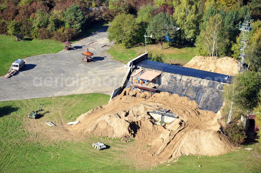 Werneuchen from the bird's eye view: Zivile Nutzung / Konversion der alten Shelter / Flugzeughallen am Flugplatz Werneuchen. Der Flugplatz diente seit den 1930er Jahren als Fliegerhorst und wurde danach von der Sowjetarmee als Flugplatz für Jagdbomber genutzt. Civilian use of the facilities of the airfield Werneuchen.