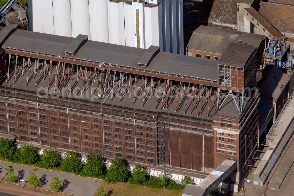 Bremen from above - High silo and grain storage with adjacent storage of J. Mueller Weser GmbH & Co. KG on street Getreidestrasse in the district Ueberseestadt in Bremen, Germany