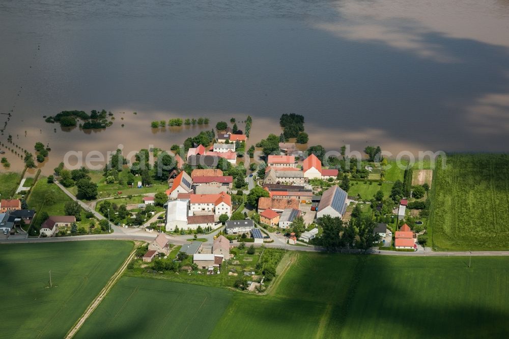 Aerial image Schänitz - The situation during the flooding in East Germany on the bank of the river Elbe in the village of Schänitz in the rural district of Meißen in the state of Saxony. Fields are flooded where the river has breached the banks