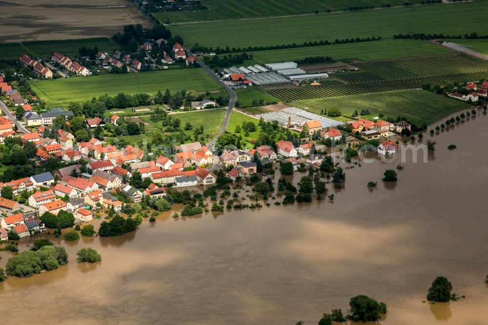 Sörnewitz from above - The situation during the flooding in East Germany on the bank of the river Elbe in the town of Sörnewitz close to Coswig in the rural district of Meißen in the state of Saxony. View from the West