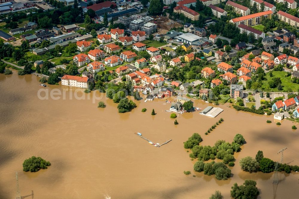 Aerial photograph Radebeul - The situation during the flooding in East Germany on the bank of the river Elbe at the city limits of Radebeul in the free state of Saxony. View on residential areas and multi family buildings. The flooded area normally consists of allotments, sports grounds, forest and fields