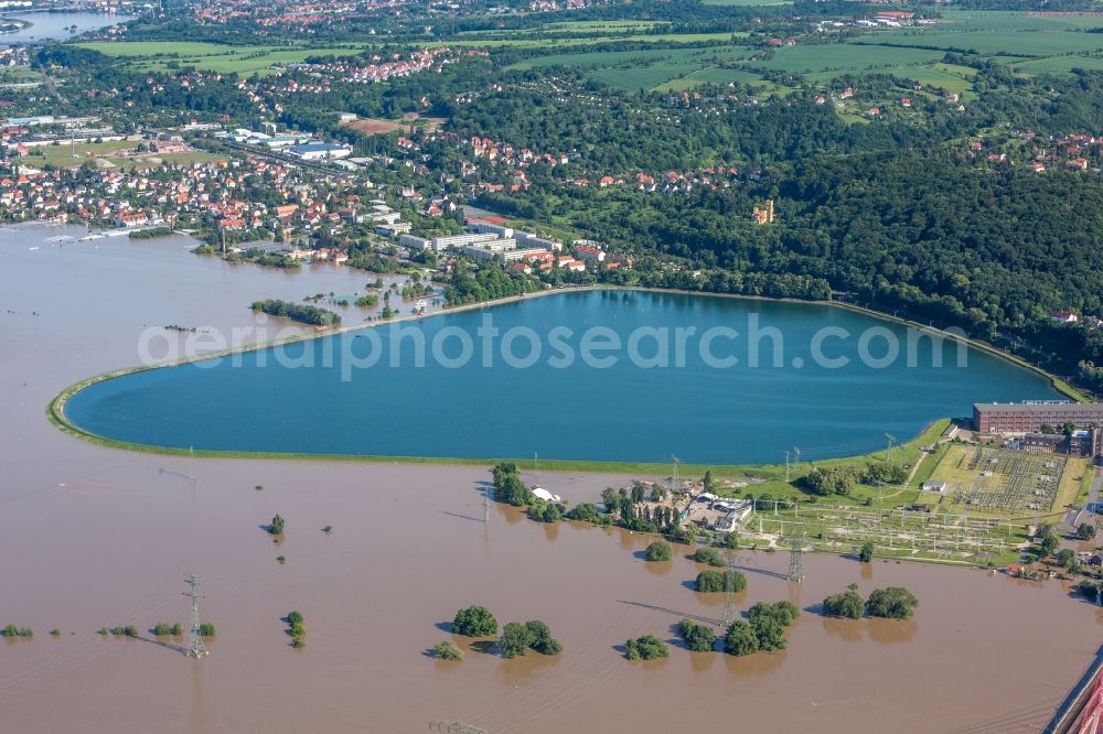 Dresden from above - The situation during the flooding in East Germany on the bank of the river Elbe in the Dresden district of Niederwartha at the Niederwartha pool in the free state of Saxony. View on the barrier lake which is enclosed by the flooding and high water level. The Niederwartha Bridge and S84 across the Elbe River is affected as well