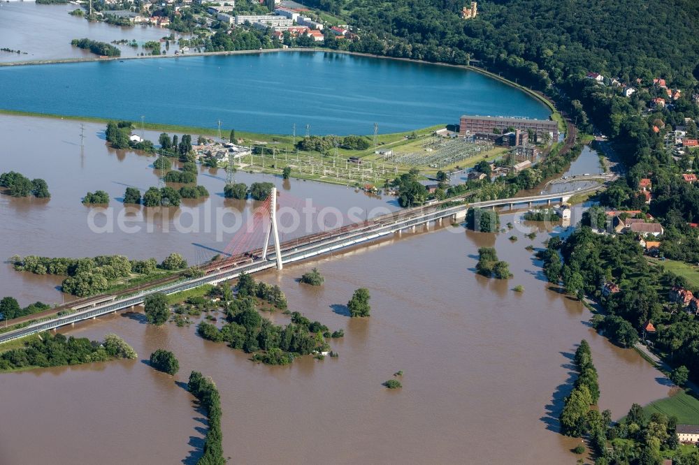 Dresden from above - The situation during the flooding in East Germany on the bank of the river Elbe in the Dresden district of Niederwartha at the Niederwartha pool in the free state of Saxony. View on the barrier lake which is enclosed by the flooding and high water level. The Niederwartha Bridge and S84 across the Elbe River is affected as well