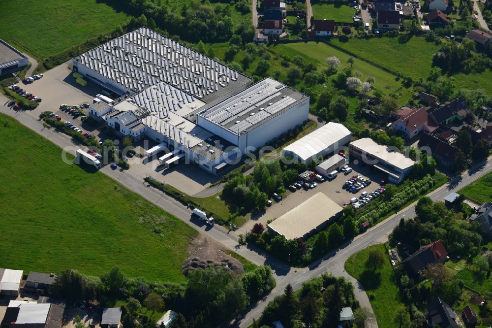 Aerial image Pölzig - Seat and company building of the HECATEC GmbH in the commerce area in Poelzig in the state of Thuringia. The white building with the parking lot is located in an industrial area. Hecatec is a producer of disposable material made from pulp