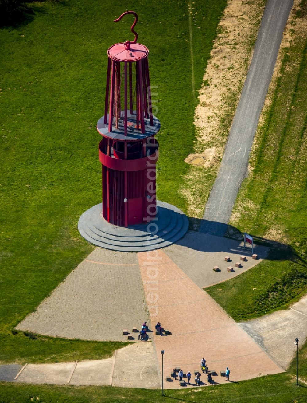 Aerial image Moers - Sculpture of an oversized red miner's lamp on the grounds of renatured Halde Rheinpreussen in Moers in North Rhine-Westphalia