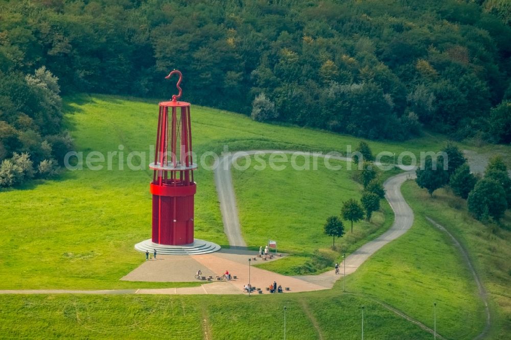 Moers from the bird's eye view: Sculpture of an oversized red miner's lamp on the grounds of renatured Halde Rheinpreussen in Moers in North Rhine-Westphalia