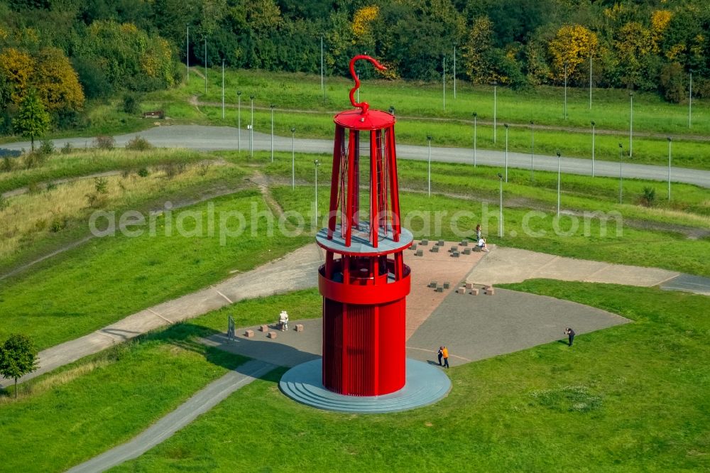 Aerial image Moers - Sculpture of an oversized red miner's lamp on the grounds of renatured Halde Rheinpreussen in Moers in North Rhine-Westphalia