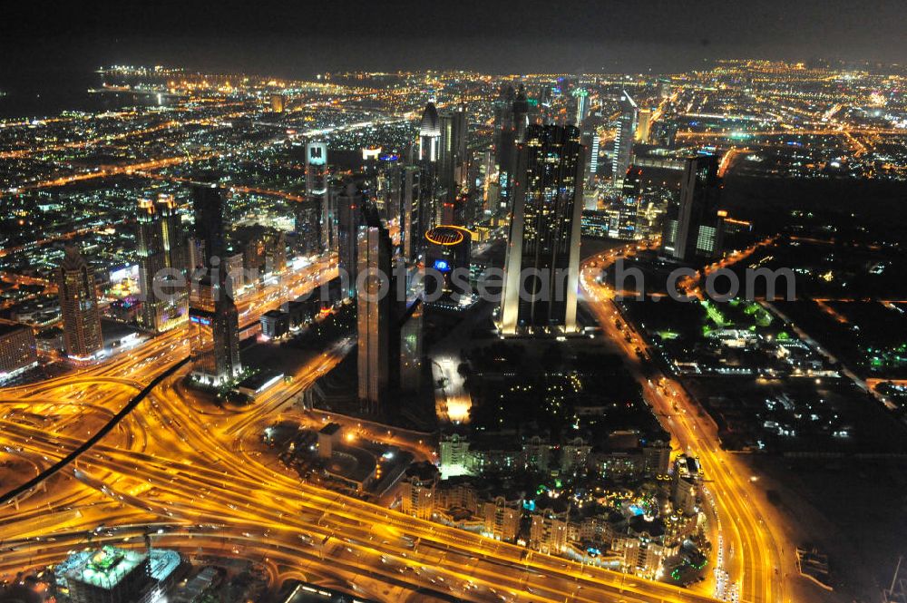 Aerial image DUBAI / DUBAYY - Nachtluftbild der neuen Skyline des Dubai an der Sheikh Zayed Road. Die frühere Trade Center Road ist die größte und bekannteste Straße Dubais, der Finanz- und Wirtschaftsmetropole des Mittleren Ostens. Night Aerial view of the new skyline of Dubai on Sheikh Zayed Road. The former Trade Center Road is the largest and most famous street of Dubai, the financial and economic hub of the Middle East.