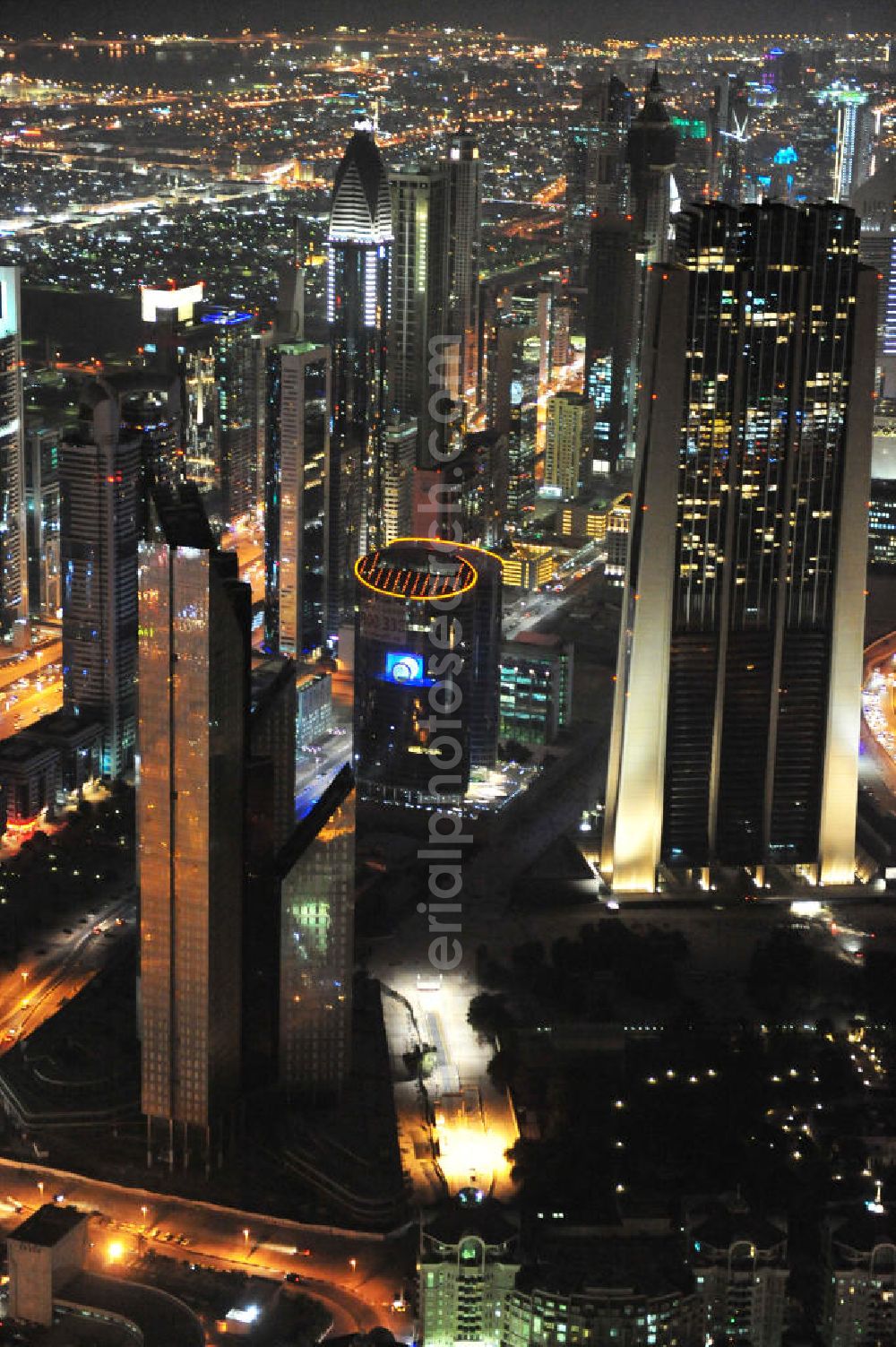 Aerial image DUBAI / DUBAYY - Nachtluftbild der neuen Skyline des Dubai an der Sheikh Zayed Road. Die frühere Trade Center Road ist die größte und bekannteste Straße Dubais, der Finanz- und Wirtschaftsmetropole des Mittleren Ostens. Night Aerial view of the new skyline of Dubai on Sheikh Zayed Road. The former Trade Center Road is the largest and most famous street of Dubai, the financial and economic hub of the Middle East.