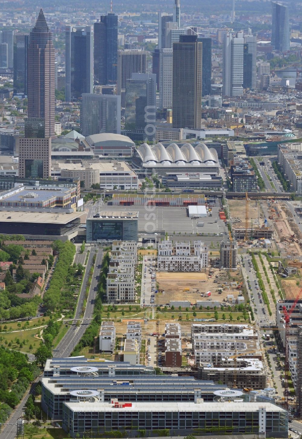 Frankfurt am Main from above - Skyline and view of the Europaviertel quarter in the Gallus part of Frankfurt in the state of Hesse. The quarter is a new downtown district on site of the former main freight yard in the Gallus part of the town. It was started in 2005 and the first high rise was opened in 2006. It will be completed in 2019 and include office buildings, hotels, appartment buildings, a school and social infrastructure such as parks and shopping facilities. The background shows the high rises and towers of downtown Frankfurt