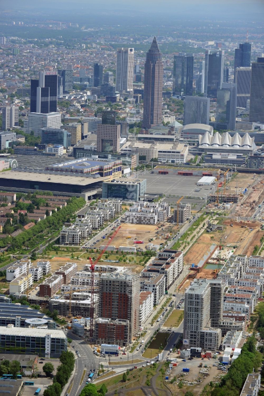 Frankfurt am Main from above - Skyline and view of the Europaviertel quarter in the Gallus part of Frankfurt in the state of Hesse. The quarter is a new downtown district on site of the former main freight yard in the Gallus part of the town. It was started in 2005 and the first high rise was opened in 2006. It will be completed in 2019 and include office buildings, hotels, appartment buildings, a school and social infrastructure such as parks and shopping facilities. The background shows the high rises and towers of downtown Frankfurt