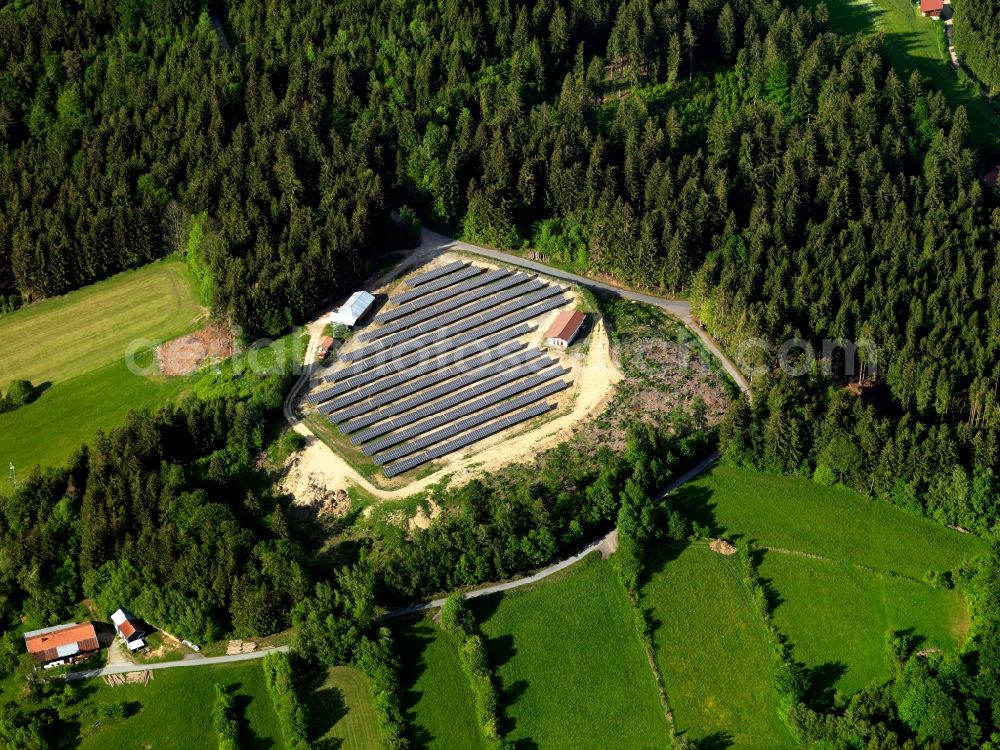 Aerial photograph Grainet - The solar plant in Grainet in the county district of Freyung-Grafenau in the state of Bavaria. The collectors are surrounded by fields, woods and acres and are placed symmetrically to collect the solar energy. The energy is then used to generate heat as well as power