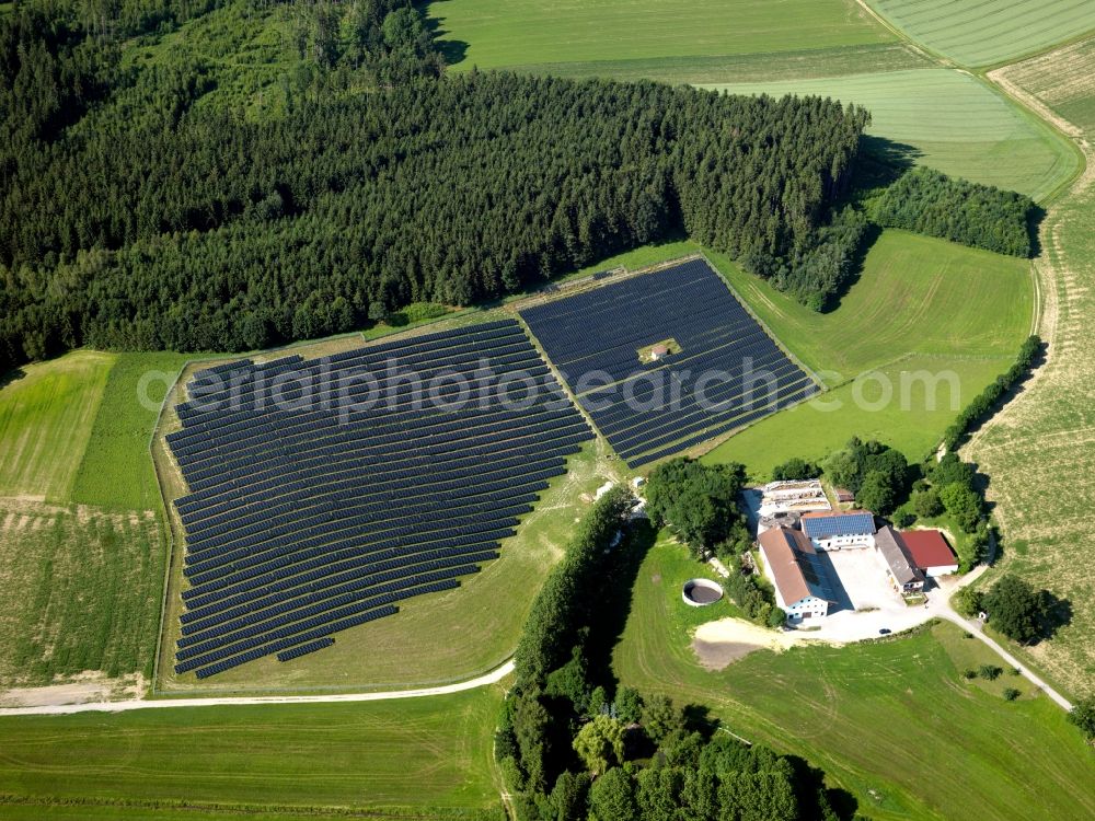 Aerial image Mühldorf am Inn - The solar plant in the county district of Mühldorf am Inn in Upper Bavaria in the state of Bavaria. The collectors are surrounded by fields and acres and are placed symmetrically to collect the solar energy. The energy is then used to generate heat as well as power