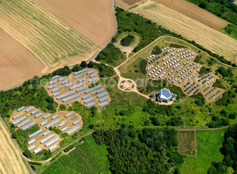 Gondorf from above - The solar plant in the county community of Gondorf in the county district of Bitburg-Prüm in the state of Rhineland-Palatinate. The collectors are surrounded by fields and acres and are placed symmetrically to collect the solar energy. The energy is then used to generate heat as well as power