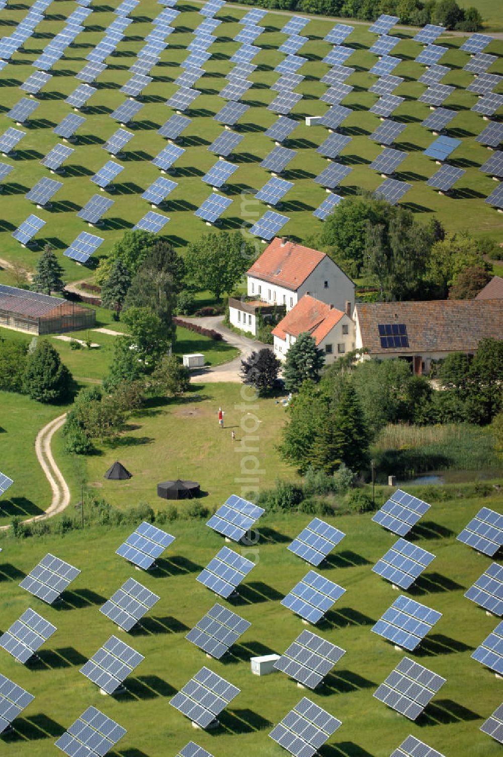 Aerial photograph Arnstein - Blick auf das Solarfeld Erlasee (auch Solarstrompark Gut Erlasee) einem 2008 auf dem ehemaligen fränkischen Weingut Erlasee bei Arnstein im Landkreis Main-Spessart (Bayern) errichtetes Solarkraftwerk. Es ist ein Gemeinschaftsprojekt des Berliner Solarmodulherstellers Solon SE, des Projektierungs- und Vertriebsunternehmens S.A.G. Solarstrom AG und der E.ON Bayern AG. Jedes Feld ist auf einem drehbaren Untergestell montiert, was eine exakte Ausrichtung der Solarmodule zur Sonne hin ermöglicht. View of the solar field Erlasee (solar Park Good Erlasee) a 2008 on the former Frankish at Weingut Erlasee Arnstein in the district Main-Spessart (Bavaria) built solar power plant.