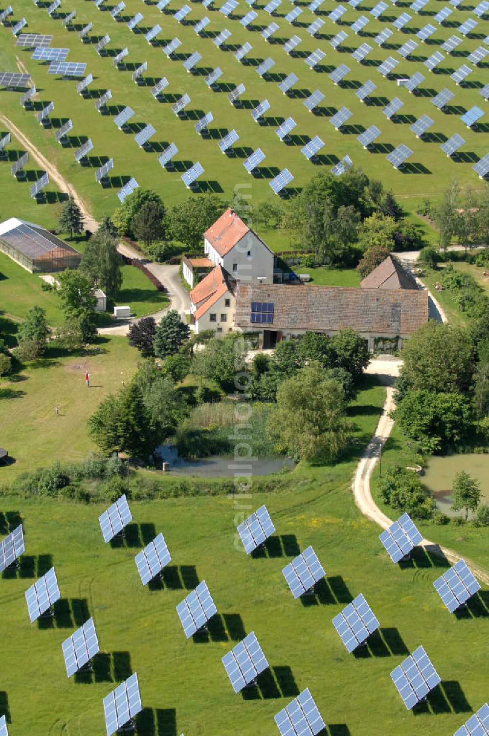 Aerial photograph Arnstein - Blick auf das Solarfeld Erlasee (auch Solarstrompark Gut Erlasee) einem 2008 auf dem ehemaligen fränkischen Weingut Erlasee bei Arnstein im Landkreis Main-Spessart (Bayern) errichtetes Solarkraftwerk. Es ist ein Gemeinschaftsprojekt des Berliner Solarmodulherstellers Solon SE, des Projektierungs- und Vertriebsunternehmens S.A.G. Solarstrom AG und der E.ON Bayern AG. Jedes Feld ist auf einem drehbaren Untergestell montiert, was eine exakte Ausrichtung der Solarmodule zur Sonne hin ermöglicht. View of the solar field Erlasee (solar Park Good Erlasee) a 2008 on the former Frankish at Weingut Erlasee Arnstein in the district Main-Spessart (Bavaria) built solar power plant.