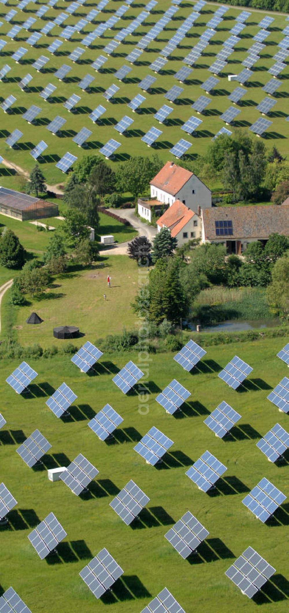 Arnstein from the bird's eye view: Blick auf das Solarfeld Erlasee (auch Solarstrompark Gut Erlasee) einem 2008 auf dem ehemaligen fränkischen Weingut Erlasee bei Arnstein im Landkreis Main-Spessart (Bayern) errichtetes Solarkraftwerk. Es ist ein Gemeinschaftsprojekt des Berliner Solarmodulherstellers Solon SE, des Projektierungs- und Vertriebsunternehmens S.A.G. Solarstrom AG und der E.ON Bayern AG. Jedes Feld ist auf einem drehbaren Untergestell montiert, was eine exakte Ausrichtung der Solarmodule zur Sonne hin ermöglicht. View of the solar field Erlasee (solar Park Good Erlasee) a 2008 on the former Frankish at Weingut Erlasee Arnstein in the district Main-Spessart (Bavaria) built solar power plant.