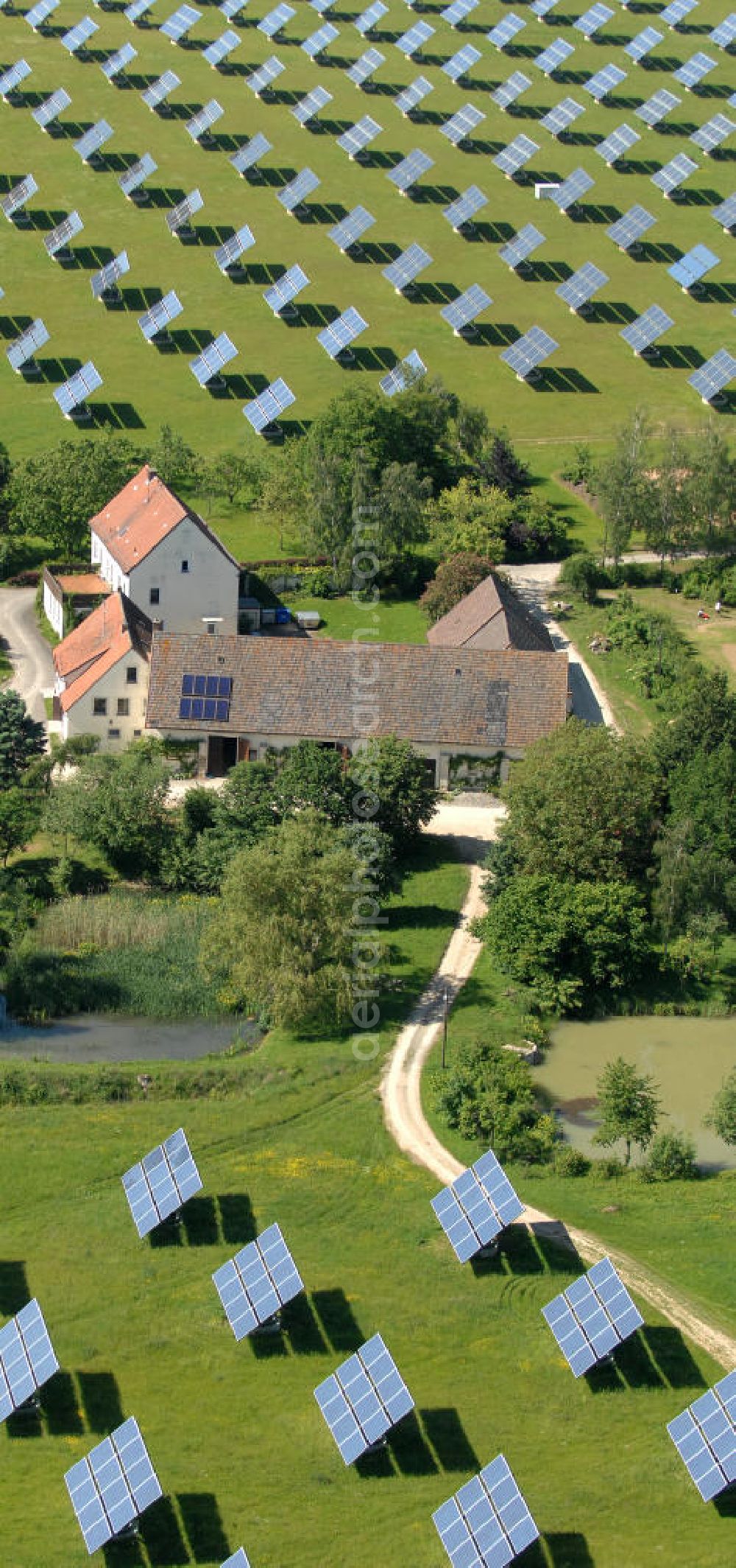 Arnstein from the bird's eye view: Blick auf das Solarfeld Erlasee (auch Solarstrompark Gut Erlasee) einem 2008 auf dem ehemaligen fränkischen Weingut Erlasee bei Arnstein im Landkreis Main-Spessart (Bayern) errichtetes Solarkraftwerk. Es ist ein Gemeinschaftsprojekt des Berliner Solarmodulherstellers Solon SE, des Projektierungs- und Vertriebsunternehmens S.A.G. Solarstrom AG und der E.ON Bayern AG. Jedes Feld ist auf einem drehbaren Untergestell montiert, was eine exakte Ausrichtung der Solarmodule zur Sonne hin ermöglicht. View of the solar field Erlasee (solar Park Good Erlasee) a 2008 on the former Frankish at Weingut Erlasee Arnstein in the district Main-Spessart (Bavaria) built solar power plant.