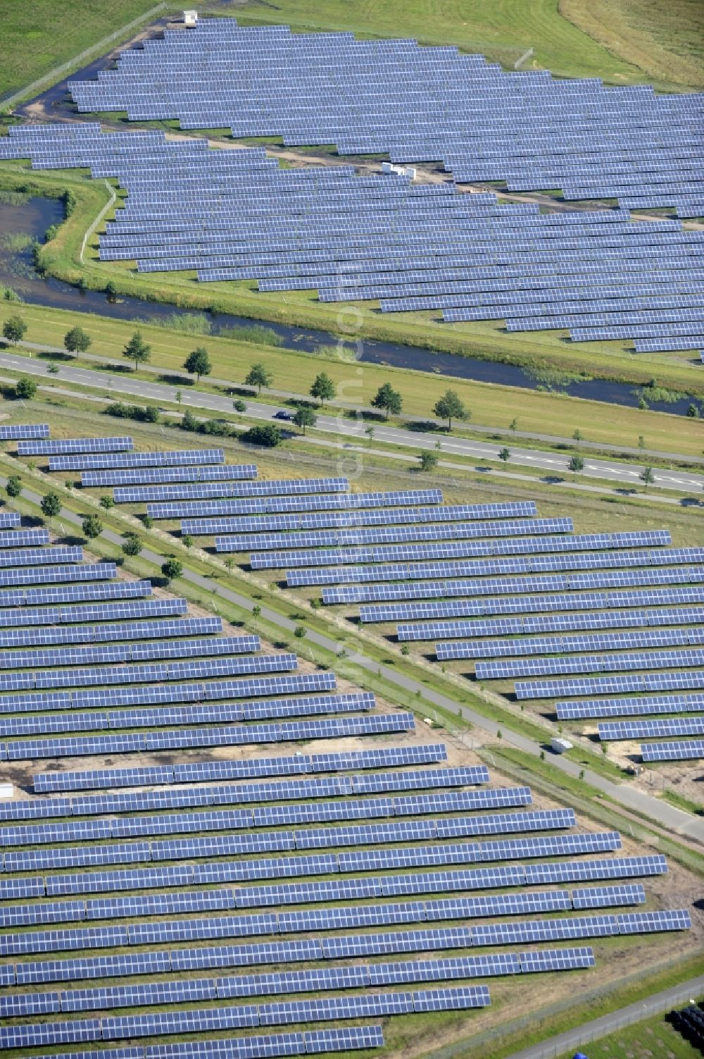 Boizenburg from above - Boizenburg 08/07/2012 Newly built solar panel, photovoltaic solar park or along the road 5 on the industrial and commercial area of the eastern edge of Boizenburg / Elbe. The plant operator is the EEPro Company