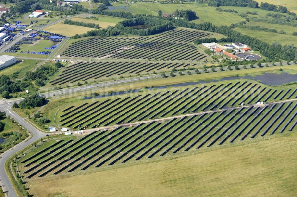 Boizenburg from the bird's eye view: Boizenburg 08/07/2012 Newly built solar panel, photovoltaic solar park or along the road 5 on the industrial and commercial area of the eastern edge of Boizenburg / Elbe. The plant operator is the EEPro Company